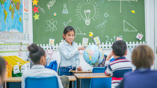 student pointing globe